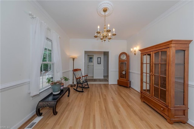 2504 William Tankard Dr, Williamsburg, VA 23185 - living area featuring a chandelier, light wood-style floors, crown molding, and baseboards