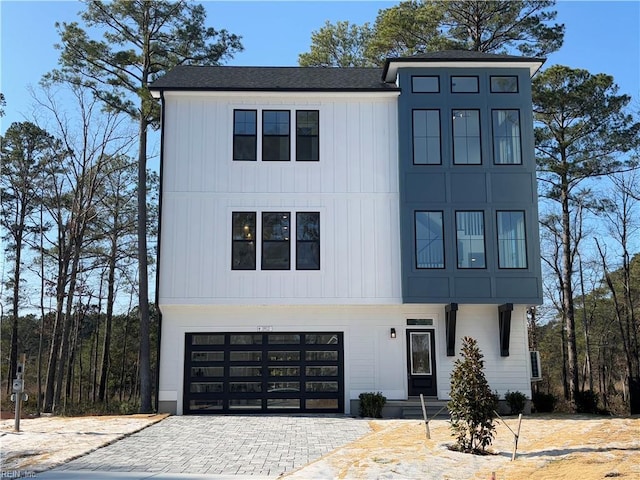 1912 Mccoy Rd, Chesapeake, VA 23323 - modern inspired farmhouse with a garage, driveway, a shingled roof, and board and batten siding