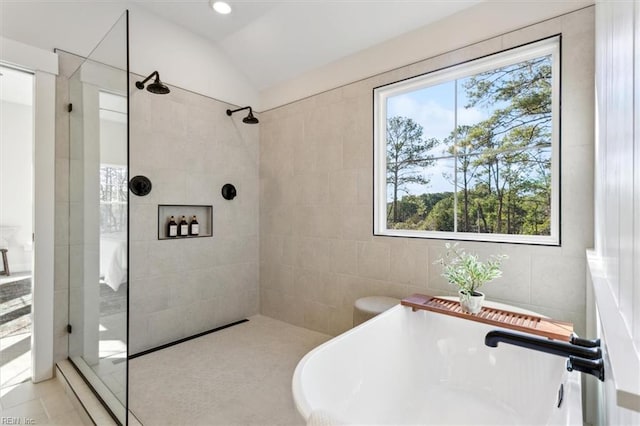 1912 Mccoy Rd, Chesapeake, VA 23323 - bathroom featuring a walk in shower, a freestanding tub, lofted ceiling, and tile walls