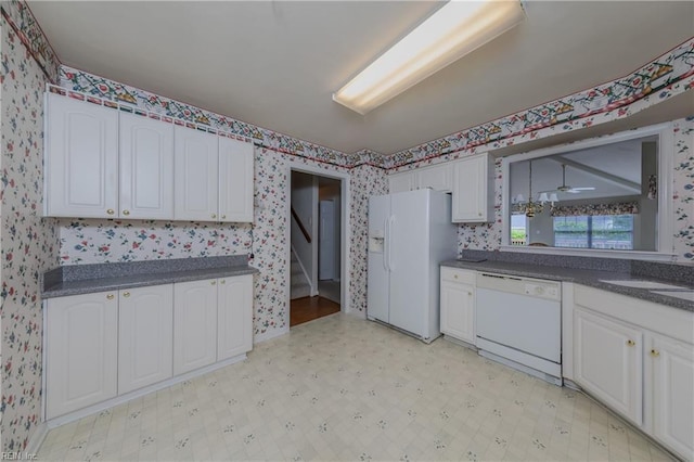 238 Wingate Dr, Williamsburg, VA 23185 - kitchen featuring white appliances, wallpapered walls, dark countertops, white cabinetry, and light flooring