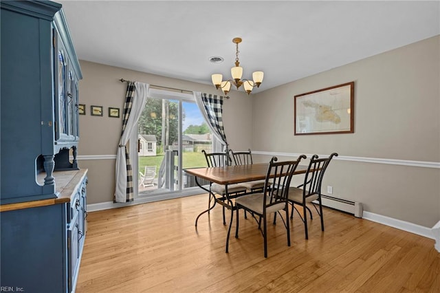 404 Briarfield Dr, Chesapeake, VA 23322 - dining area featuring a chandelier, baseboards, light wood-style floors, and a baseboard radiator