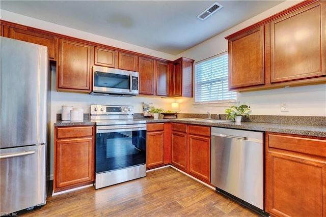 5233 Winery Dr, Chesapeake, VA 23321 - kitchen featuring stainless steel appliances, dark countertops, dark wood-style floors, and a sink