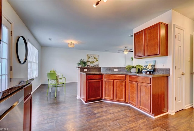 5233 Winery Dr, Chesapeake, VA 23321 - kitchen featuring a peninsula, dark wood finished floors, ceiling fan, baseboards, and dark stone countertops
