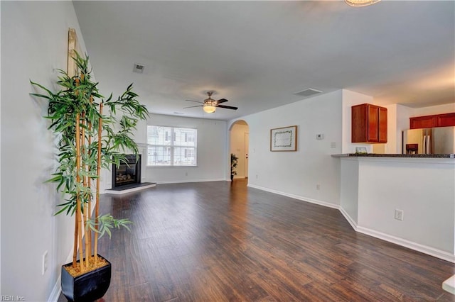 5233 Winery Dr, Chesapeake, VA 23321 - unfurnished living room featuring arched walkways, dark wood finished floors, and baseboards