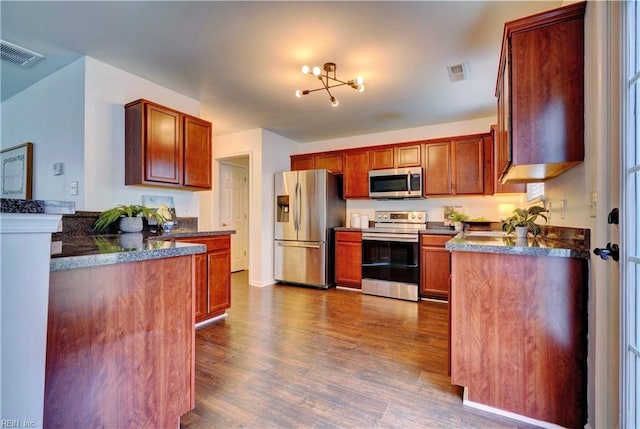 5233 Winery Dr, Chesapeake, VA 23321 - kitchen featuring appliances with stainless steel finishes, dark wood-type flooring, and a chandelier