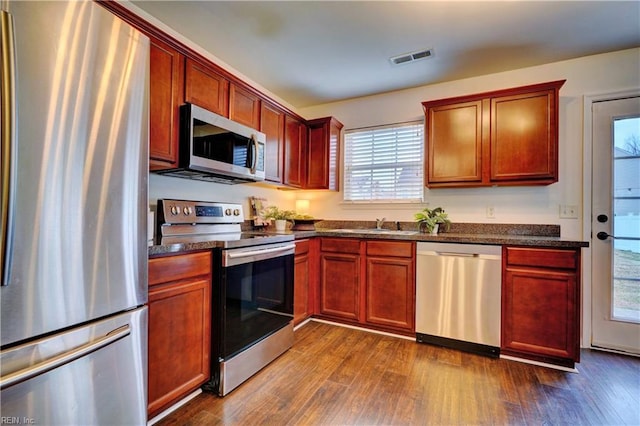 5233 Winery Dr, Chesapeake, VA 23321 - kitchen featuring appliances with stainless steel finishes, dark wood-style flooring, plenty of natural light, and dark brown cabinets