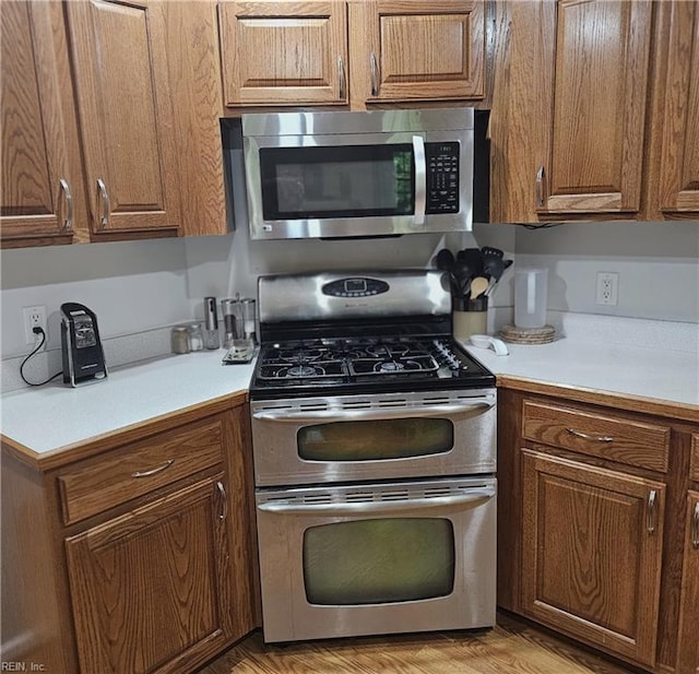 520 Hickory Cres, Smithfield, VA 23430 - kitchen featuring appliances with stainless steel finishes, light countertops, and brown cabinets