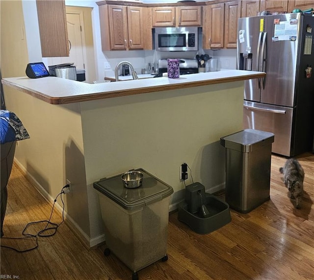 520 Hickory Cres, Smithfield, VA 23430 - kitchen with appliances with stainless steel finishes, wood finished floors, brown cabinets, and baseboards