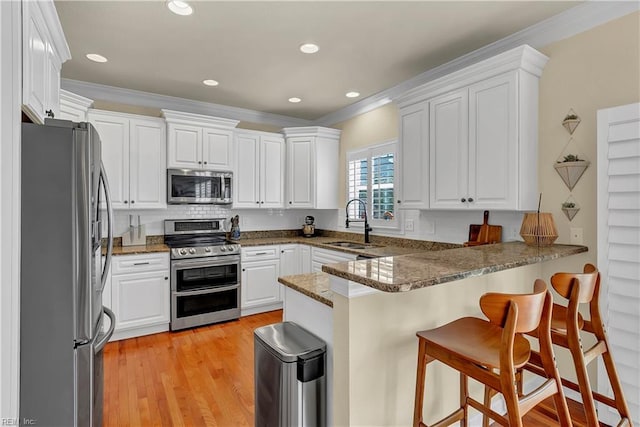 921 Justin Lee Way, Chesapeake, VA 23322 - kitchen featuring stainless steel appliances, a peninsula, a sink, ornamental molding, and backsplash