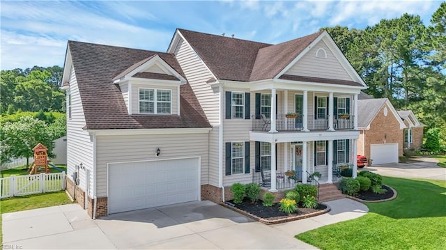 921 Justin Lee Way, Chesapeake, VA 23322 - greek revival house with a porch, a balcony, a garage, concrete driveway, and brick siding