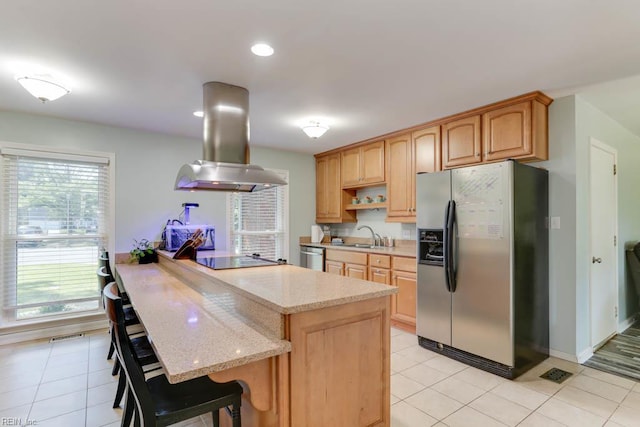 20 Hatteras Lndg, Hampton, VA 23669 - kitchen featuring appliances with stainless steel finishes, island range hood, a sink, light stone counters, and a kitchen breakfast bar