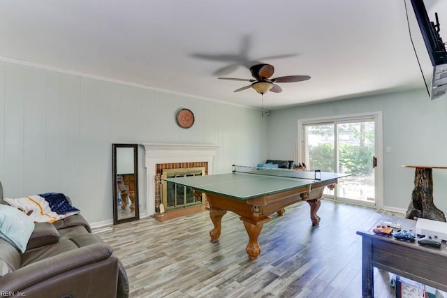20 Hatteras Lndg, Hampton, VA 23669 - game room featuring light wood-style flooring, a ceiling fan, a brick fireplace, and baseboards