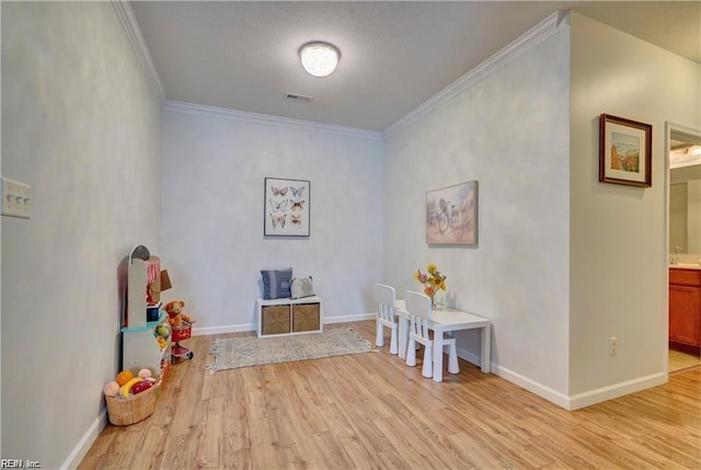 401 Blue Heron Trl, Carrollton, VA 23314 - game room with light wood-style flooring, ornamental molding, and baseboards