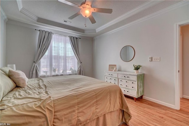 401 Blue Heron Trl, Carrollton, VA 23314 - bedroom with a tray ceiling, light wood finished floors, crown molding, baseboards, and a ceiling fan