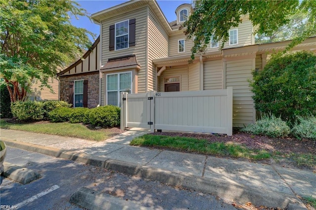 401 Blue Heron Trl, Carrollton, VA 23314 - view of front of property with a gate, stone siding, and board and batten siding