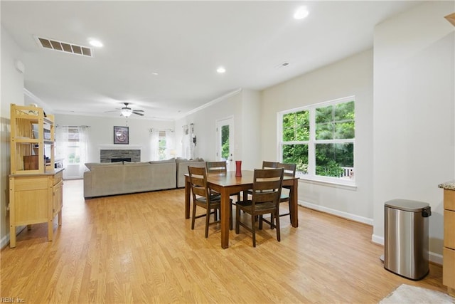 700 Dickens Pl, Chesapeake, VA 23322 - dining room featuring a ceiling fan, a fireplace, plenty of natural light, light wood-style flooring, and recessed lighting