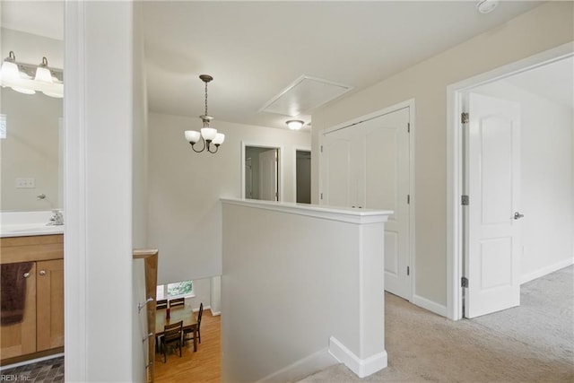 700 Dickens Pl, Chesapeake, VA 23322 - hallway featuring attic access, an upstairs landing, baseboards, and a sink