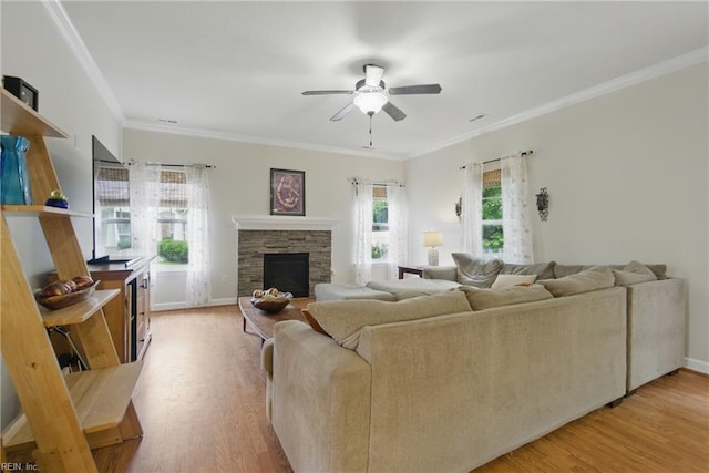 700 Dickens Pl, Chesapeake, VA 23322 - living area with wood finished floors, a stone fireplace, a ceiling fan, crown molding, and baseboards