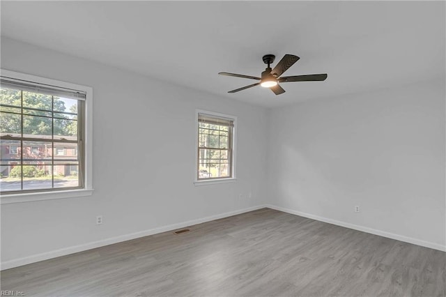 392 Deputy Ln Unit D, Newport News, VA 23608 - empty room featuring healthy amount of natural light, wood finished floors, and ceiling fan