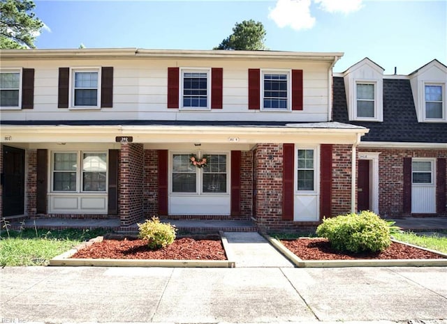 392 Deputy Ln Unit D, Newport News, VA 23608 - view of front of home with brick siding, covered porch, and roof with shingles