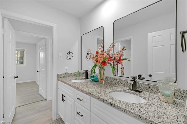 392 Deputy Ln Unit D, Newport News, VA 23608 - bathroom with double vanity, wood finished floors, and baseboards