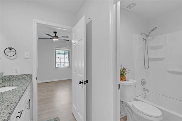 392 Deputy Ln Unit D, Newport News, VA 23608 - bathroom with vanity, a ceiling fan, toilet, wood finished floors, and  shower combination