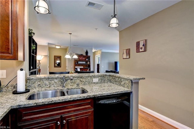 5413 Foundation St, Williamsburg, VA 23188 - kitchen with black dishwasher, a sink, baseboards, light stone countertops, and decorative light fixtures