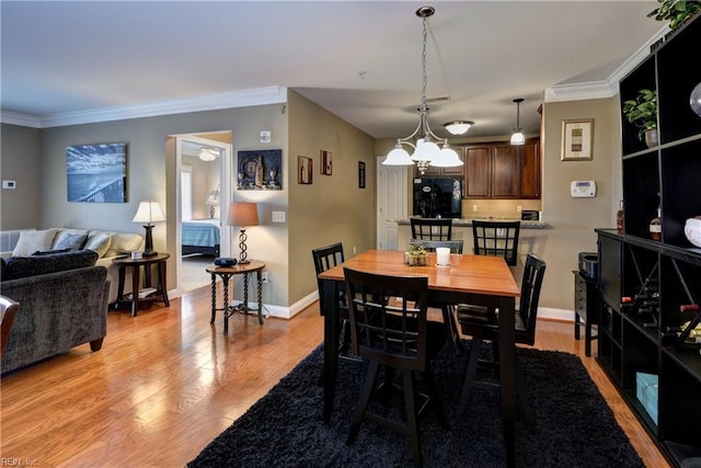 5413 Foundation St, Williamsburg, VA 23188 - dining room with light wood finished floors, crown molding, and baseboards