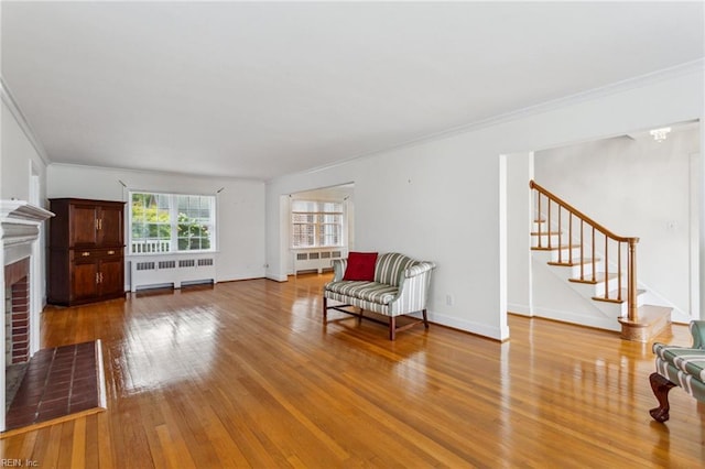 3403 Chesapeake Ave, Hampton, VA 23661 - sitting room with radiator, a brick fireplace, stairway, crown molding, and hardwood / wood-style flooring