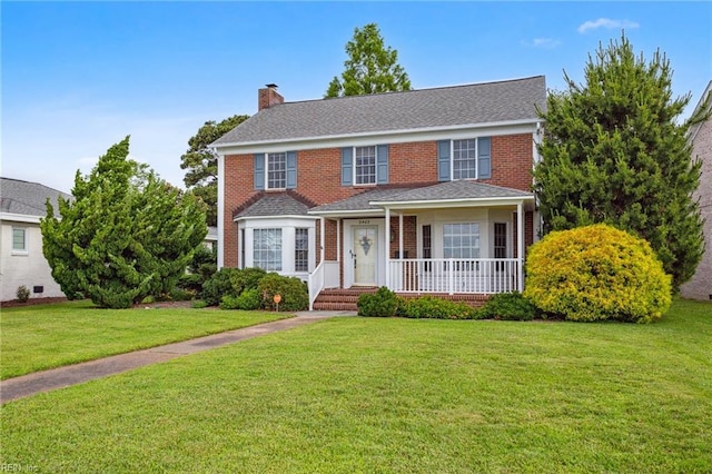 3403 Chesapeake Ave, Hampton, VA 23661 - view of front facade with a chimney, a front yard, and brick siding