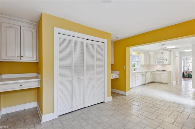 3403 Chesapeake Ave, Hampton, VA 23661 - unfurnished living room with baseboards, healthy amount of natural light, a sink, and light stone finish flooring
