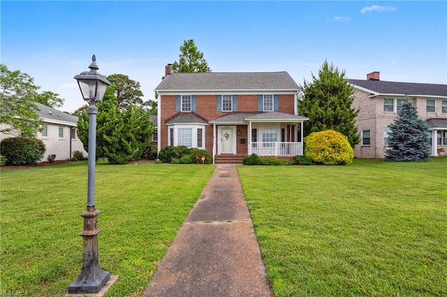 3403 Chesapeake Ave, Hampton, VA 23661 - traditional-style house featuring a front yard, a chimney, covered porch, and brick siding
