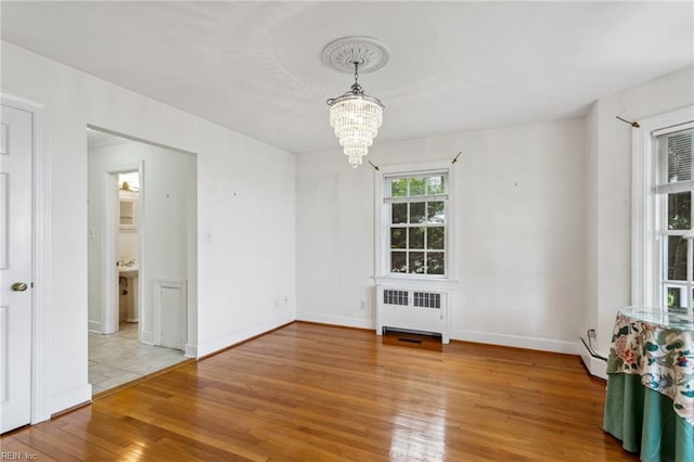 3403 Chesapeake Ave, Hampton, VA 23661 - unfurnished dining area featuring radiator, a chandelier, wood finished floors, baseboard heating, and baseboards