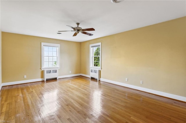 3403 Chesapeake Ave, Hampton, VA 23661 - spare room featuring radiator, baseboards, a ceiling fan, and wood finished floors