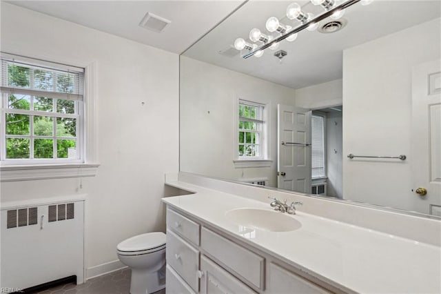 3403 Chesapeake Ave, Hampton, VA 23661 - bathroom featuring radiator heating unit, vanity, plenty of natural light, and toilet
