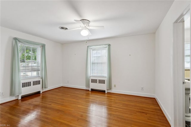 3403 Chesapeake Ave, Hampton, VA 23661 - empty room with radiator heating unit, wood finished floors, ceiling fan, and baseboards
