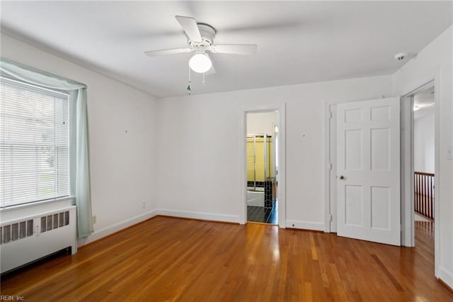3403 Chesapeake Ave, Hampton, VA 23661 - unfurnished bedroom featuring radiator, wood finished floors, baseboards, and ceiling fan