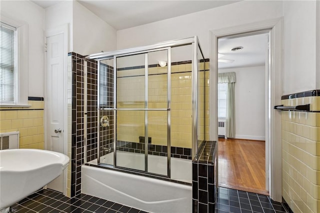 3403 Chesapeake Ave, Hampton, VA 23661 - bathroom with tile walls, enclosed tub / shower combo, radiator heating unit, and a wainscoted wall