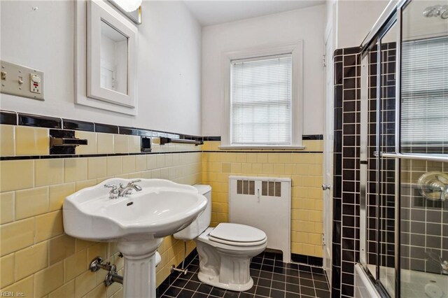 3403 Chesapeake Ave, Hampton, VA 23661 - full bath with radiator heating unit, tile walls, a wainscoted wall, tile patterned flooring, and toilet