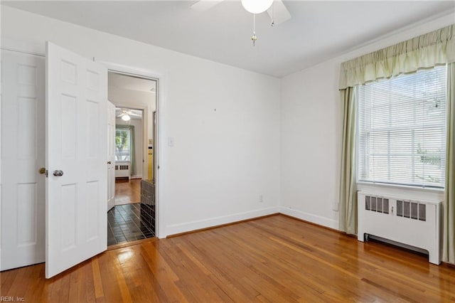 3403 Chesapeake Ave, Hampton, VA 23661 - empty room featuring radiator, a ceiling fan, and hardwood / wood-style flooring