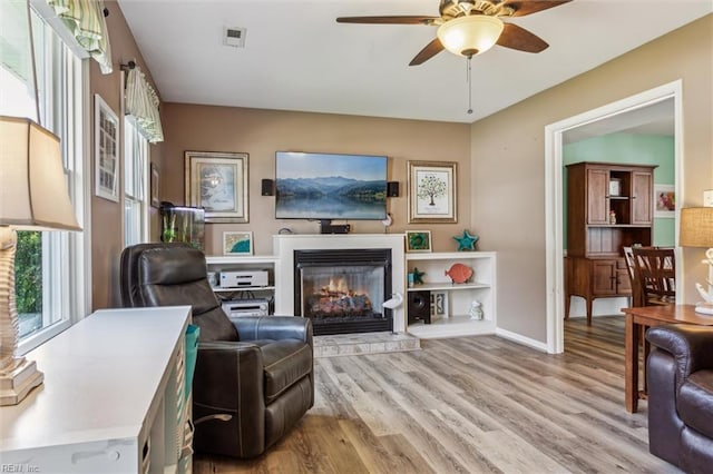 107 Benson Dr, Hampton, VA 23664 - living area with a glass covered fireplace, light wood-style floors, a ceiling fan, and baseboards