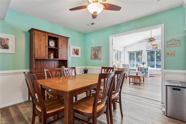 107 Benson Dr, Hampton, VA 23664 - dining room featuring a ceiling fan, a wainscoted wall, light wood-style floors, and a baseboard radiator