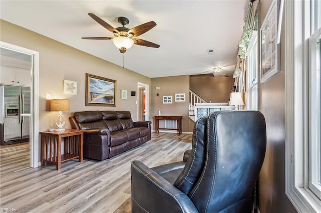107 Benson Dr, Hampton, VA 23664 - living area with light wood finished floors, ceiling fan, baseboards, and stairway