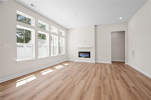 2300 Venture Way Unit B, Suffolk, VA 23434 - unfurnished living room featuring light wood-style floors, baseboards, a glass covered fireplace, and recessed lighting