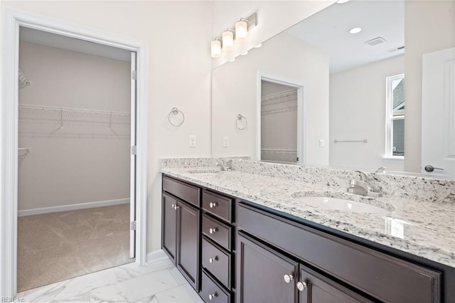 2300 Venture Way Unit B, Suffolk, VA 23434 - bathroom featuring double vanity, a walk in closet, marble look tiles, baseboards, and recessed lighting