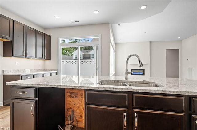 2300 Venture Way Unit B, Suffolk, VA 23434 - kitchen with a sink, dark brown cabinetry, light stone counters, light wood finished floors, and recessed lighting