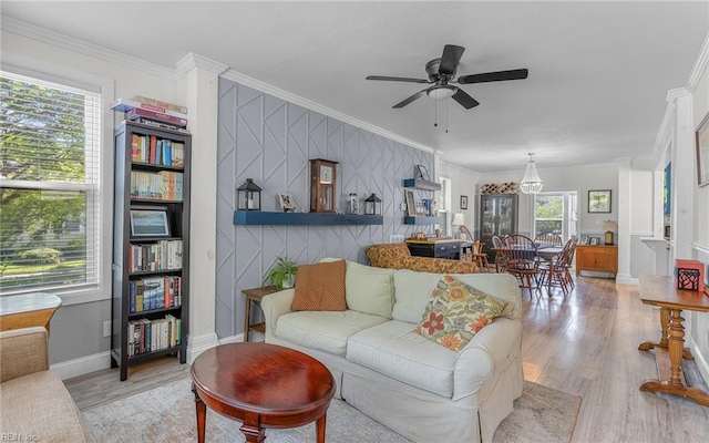 4201 Newport Ave, Norfolk, VA 23508 - living room with light wood-style flooring, a ceiling fan, crown molding, an accent wall, and baseboards