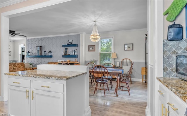 4201 Newport Ave, Norfolk, VA 23508 - kitchen featuring light wood-type flooring, white cabinetry, light stone countertops, a chandelier, and ornamental molding