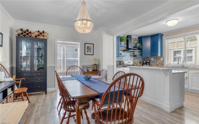 4201 Newport Ave, Norfolk, VA 23508 - dining space featuring light wood-style floors, a chandelier, healthy amount of natural light, and crown molding