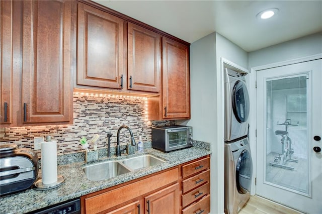 3521 Wayne St, Virginia Beach, VA 23452 - laundry room with a sink, estacked washer and dryer, light wood-style floors, and recessed lighting